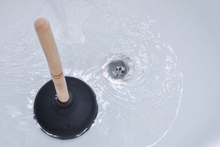 Plunger and clogged bath drain.