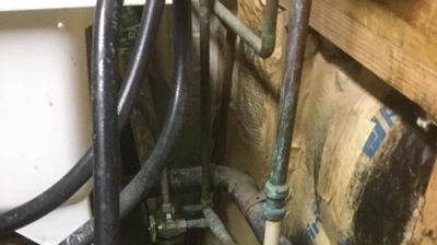 Leaking Pipe Behind Laundry Photo