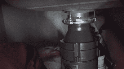Technician Up Close and Personal with Garbage Disposal Photo