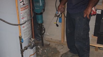 Tech Pouring Water on Concrete Photo