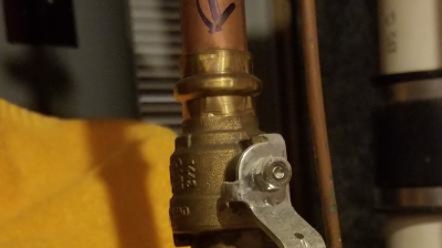 Lever valves are the most current type of shut off valve. This is one for the whole house. Photo