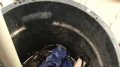 Sump Pump Pit Full of Trash and Debris Photo