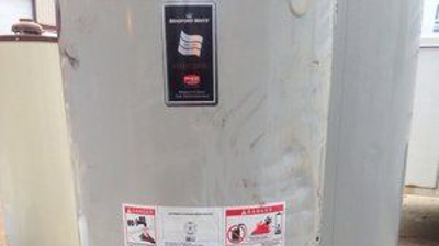 Damaged water heater that started a slow leak and was caught before there was major damage given the water alarm in place. Photo