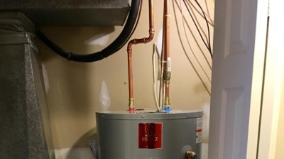 Electric Water Heater in Utility Closet Photo